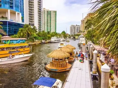 a group of boats in a river with buildings at The Residences at Lake Ridge Apt 3 in Fort Lauderdale