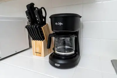 a black coffee maker sitting on a kitchen counter at The Residences at Lake Ridge Apt 3 in Fort Lauderdale