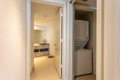 a kitchen with a washer and dryer in a room at LYFE on the Beach 25th floor 1 bed unit with Oceanview in Hollywood