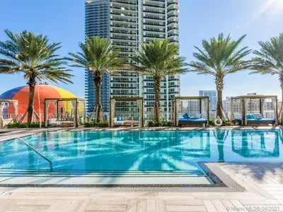 a swimming pool with palm trees and buildings at LYFE on the Beach 25th floor 1 bed unit with Oceanview in Hollywood