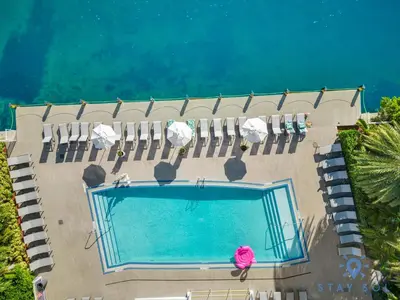 an overhead view of a swimming pool with lawn chairs and avisor at Amazing View - Pool - Gym - 2 Bedrooms in Hallandale Beach