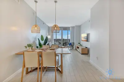 a dining room with a table and chairs at Upper Apartment - Pool - Gym - Near Beach in Hallandale Beach
