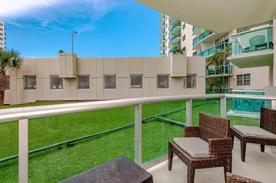 a balcony of a building with chairs and grass at Hollywood on The Beach in Hollywood