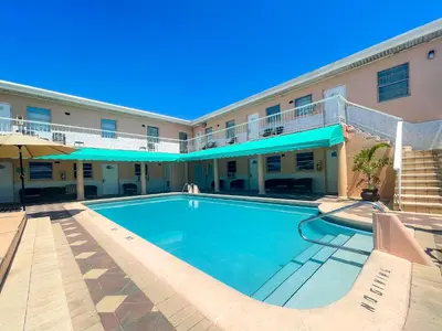 a swimming pool in front of a hotel at Coastal Sunset in Hollywood