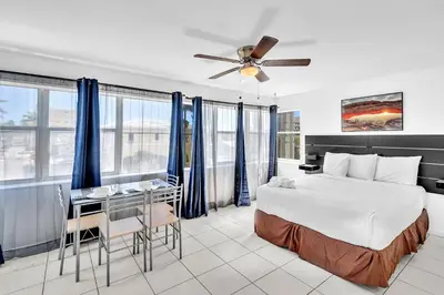a hotel room with a bed and a desk and a bed at Coastal Sunset in Hollywood
