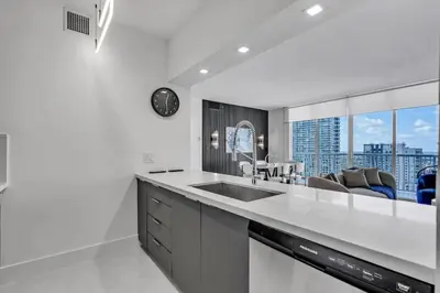a kitchen with a sink and a view of a city at Luxe Brickell Gem with Huge Balcony n Ocean Views in Miami
