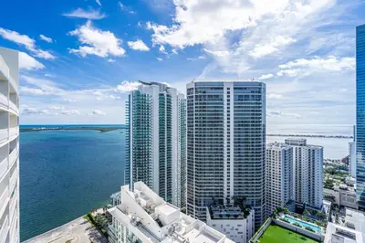 a view of a city with the ocean and buildings at Luxe Brickell Gem with Huge Balcony n Ocean Views in Miami