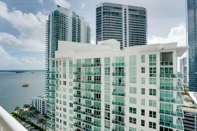 a view of a building in front of some tall buildings at Stylish 1BR APT with Ocean and City view,pool,parking in Miami