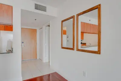 a hallway with two mirrors on a wall at Stylish 1BR APT with Ocean and City view,pool,parking in Miami