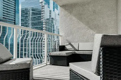 a balcony with chairs and a view of a city at Stylish 1BR APT with Ocean and City view,pool,parking in Miami