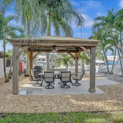 a gazebo with chairs and a table in a park at Beach Isles Modern Studio Apartment in Fort Lauderdale in Fort Lauderdale