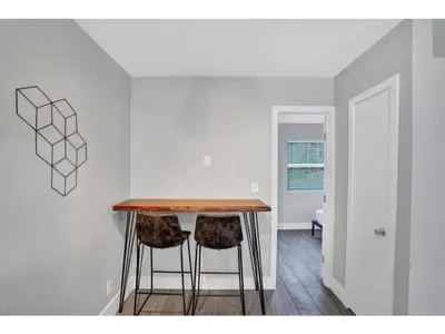 a kitchen with a table and two stools at Rustic Retreats Beachy 1BR for 4 guests in the heart of Fort Lauderdale in Fort Lauderdale