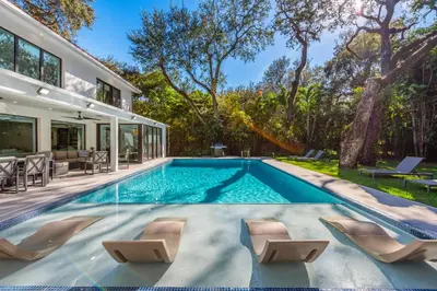 a swimming pool in the backyard of a house at Villa Arielle in Miami