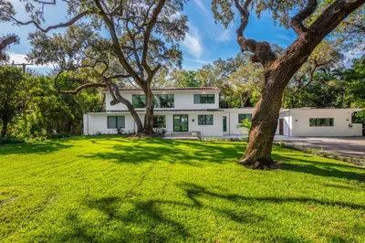 an exterior view of a white house with trees at Villa Arielle in Miami
