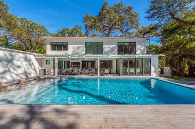 a swimming pool in front of a house at Villa Arielle in Miami