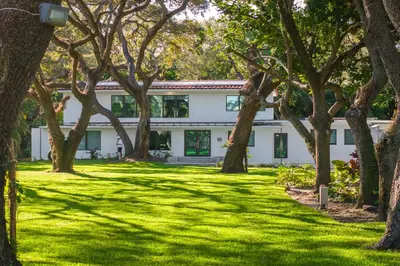 a white building with trees in front of it at Villa Arielle in Miami
