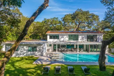 an exterior view of a house with a swimming pool at Villa Arielle in Miami