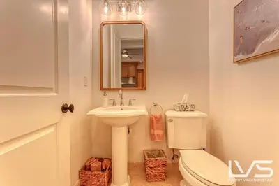 a bathroom with a toilet and a sink and a mirror at LVS Villa Alba- Walk2LasOlas, HeatedPool, RoofTopTerrace in Fort Lauderdale