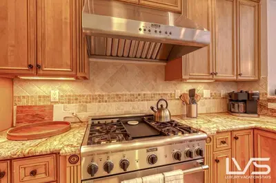 a kitchen with a stove and a microwave at LVS Villa Alba- Walk2LasOlas, HeatedPool, RoofTopTerrace in Fort Lauderdale