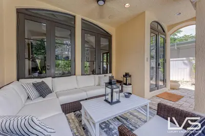 a living room with a white couch and a table at LVS Villa Alba- Walk2LasOlas, HeatedPool, RoofTopTerrace in Fort Lauderdale
