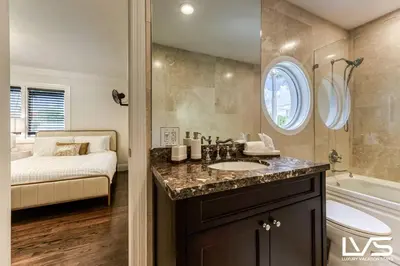 a bathroom with a sink and a tub and a bed at Poinciana-LuxeHome Wlk2Beach HeatedPool HotTub in Fort Lauderdale