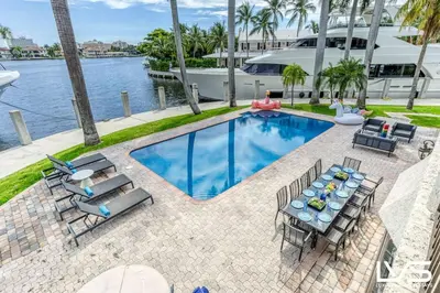 an overhead view of a swimming pool with a table and chairs at VillaKey- LUXE Waterfront Villa 5Min to Beach in Fort Lauderdale