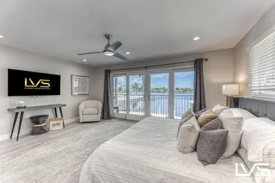a bedroom with a bed and a large window at VillaKey- LUXE Waterfront Villa 5Min to Beach in Fort Lauderdale