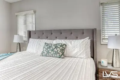 a bedroom with a large bed with white sheets and pillows at VillaKey- LUXE Waterfront Villa 5Min to Beach in Fort Lauderdale
