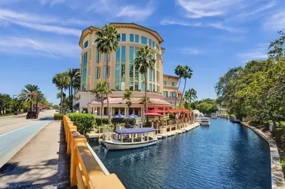 a hotel with boats in a canal in front of a building at Beach Isles Modern 1BR in Fort Lauderdale with Patio in Fort Lauderdale