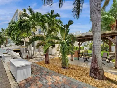 a patio with palm trees and a pavilion at Beach Isles Modern 1BR in Fort Lauderdale with Patio in Fort Lauderdale