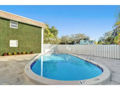 a large swimming pool in front of a building at Rustic Retreats Modern 1BR for 4 guests in the heart of Fort Lauderdale in Fort Lauderdale