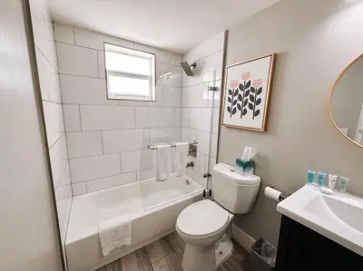 a bathroom with a toilet and a tub and a sink at Rustic Retreats Cozy 1BR For 4 Guests Minutes From Las Olas in Fort Lauderdale