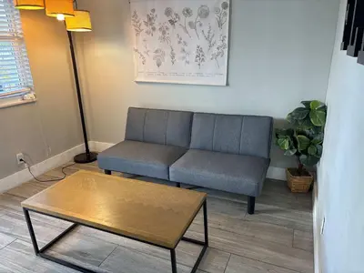 a living room with a couch and a coffee table at Rustic Retreats Cozy 1BR For 4 Guests Minutes From Las Olas in Fort Lauderdale
