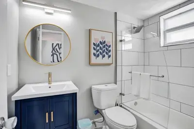 a bathroom with a toilet and a sink and a mirror at Rustic Retreats Modern 1BR For 4 Guests Minutes From Las Olas in Fort Lauderdale