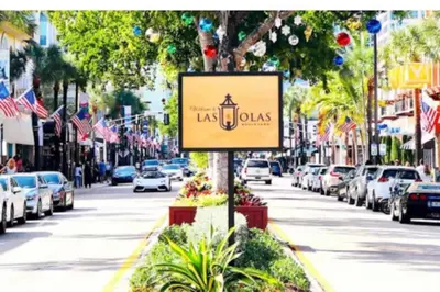 a sign on a street with cars parked at Rustic Retreats Spacious 1BR For 4 guests In The Heart of Fort Lauderdale in Fort Lauderdale