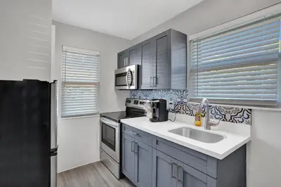 a kitchen with a sink and a stove at Rustic Retreats Spacious 1BR For 4 guests In The Heart of Fort Lauderdale in Fort Lauderdale