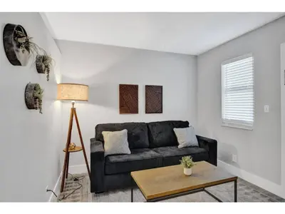 a living room with a couch and a table at Rustic Retreats Cozy 1BR For 4 Guests In The Heart Of Fort Lauderdale in Fort Lauderdale