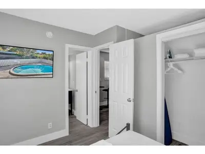a room with a bed and a painting on the wall at Rustic Retreats Cozy 1BR For 4 Guests In The Heart Of Fort Lauderdale in Fort Lauderdale