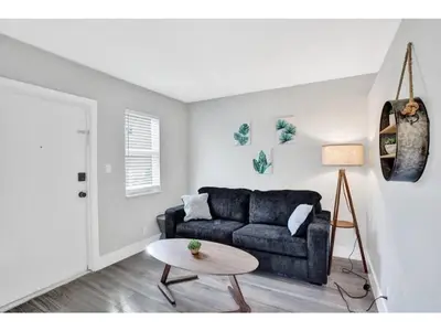 a living room with a couch and a table at Rustic Retreats Cozy 1BR for 4 guests minutes from Las Olas in Fort Lauderdale