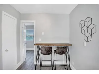 a kitchen with a wooden table and two stools at Rustic Retreats Cozy 1BR for 4 guests minutes from Las Olas in Fort Lauderdale
