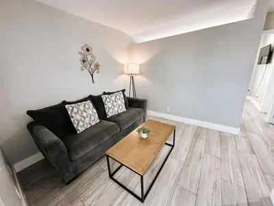 a living room with a couch and a table at Rustic Retreats Cozy 1BR for 4 guests minutes from Las Olas in Fort Lauderdale