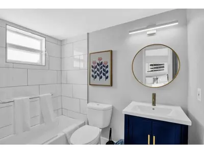 a bathroom with a sink and a toilet and a mirror at Rustic Retreats Modern 1BR for 4 guests in the heart of Fort Lauderdale in Fort Lauderdale