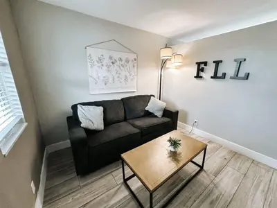 a living room with a couch and a table at Rustic Retreats Beachy 1BR for 4 guests in the heart of Fort Lauderdale in Fort Lauderdale