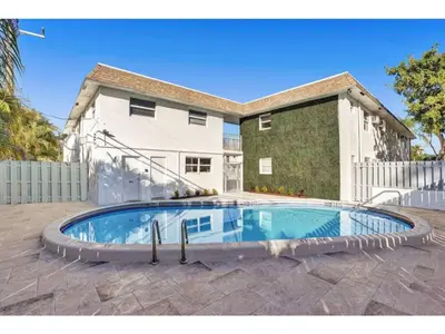 a swimming pool in front of a house at Rustic Retreats Beachy 1BR for 4 guests in the heart of Fort Lauderdale in Fort Lauderdale