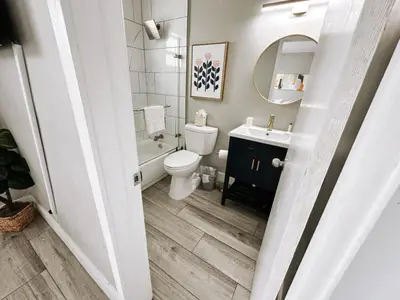 a bathroom with a toilet and a sink and a mirror at Rustic Retreats Beachy 1BR for 4 guests in the heart of Fort Lauderdale in Fort Lauderdale