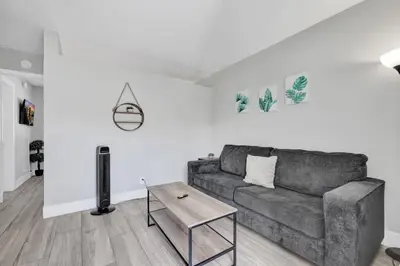 a living room with a couch and a table at Rustic Retreats Cozy 1BR For 4 Guests Minutes From Las Olas in Fort Lauderdale