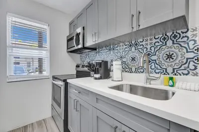 a kitchen with a sink and a stove at Rustic Retreats Cozy 1BR For 4 Guests Minutes From Las Olas in Fort Lauderdale