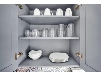 a pantry with plates and bowls on shelves at Rustic Retreats Cozy 1BR For 4 Guests Minutes From Las Olas in Fort Lauderdale