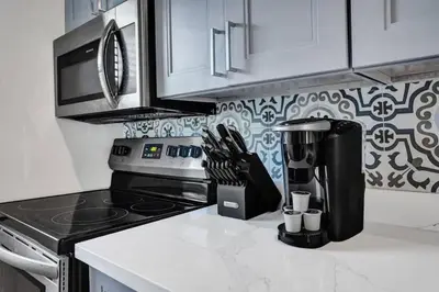 a kitchen with a coffee maker on a counter at Rustic Retreats Cozy 1BR For 4 Guests In The Heart Of Fort Lauderdale in Fort Lauderdale