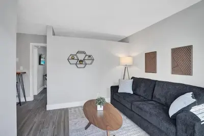 a living room with a couch and a table at Rustic Retreats Cozy 1BR For 4 Guests In The Heart Of Fort Lauderdale in Fort Lauderdale